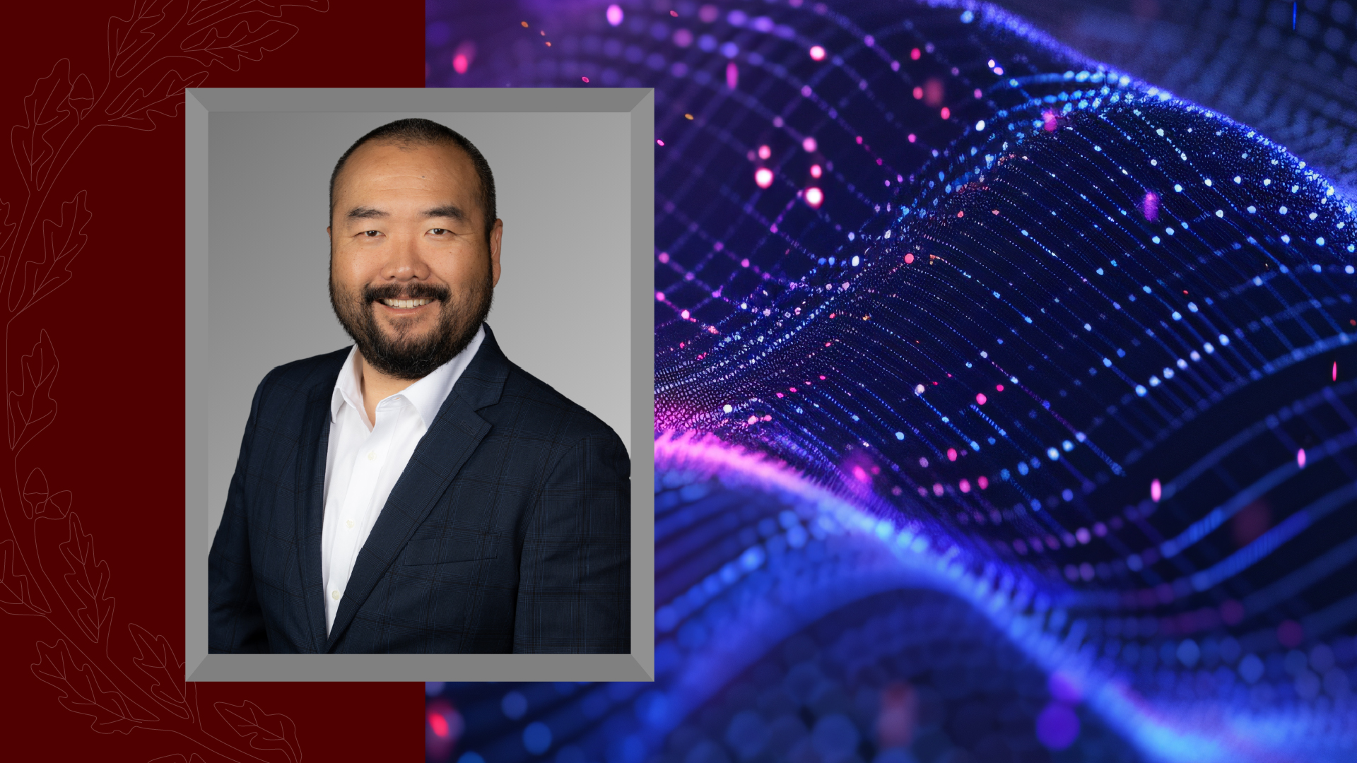 Headshot of a man in a suit against a graphic background featuring maroon accents and an abstract blue digital wave.
